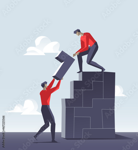 Uomini che costruiscono muro fatto di elementi di varie forme geometriche