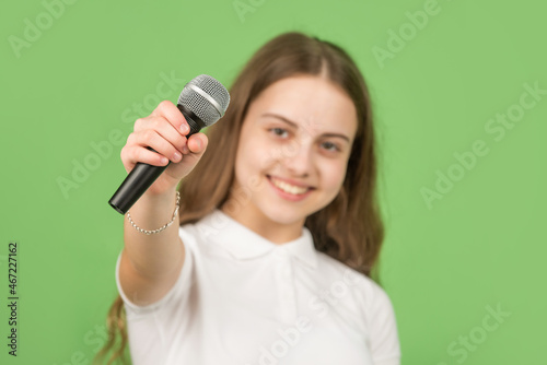 microphone in hand of happy kid, selective focus, music