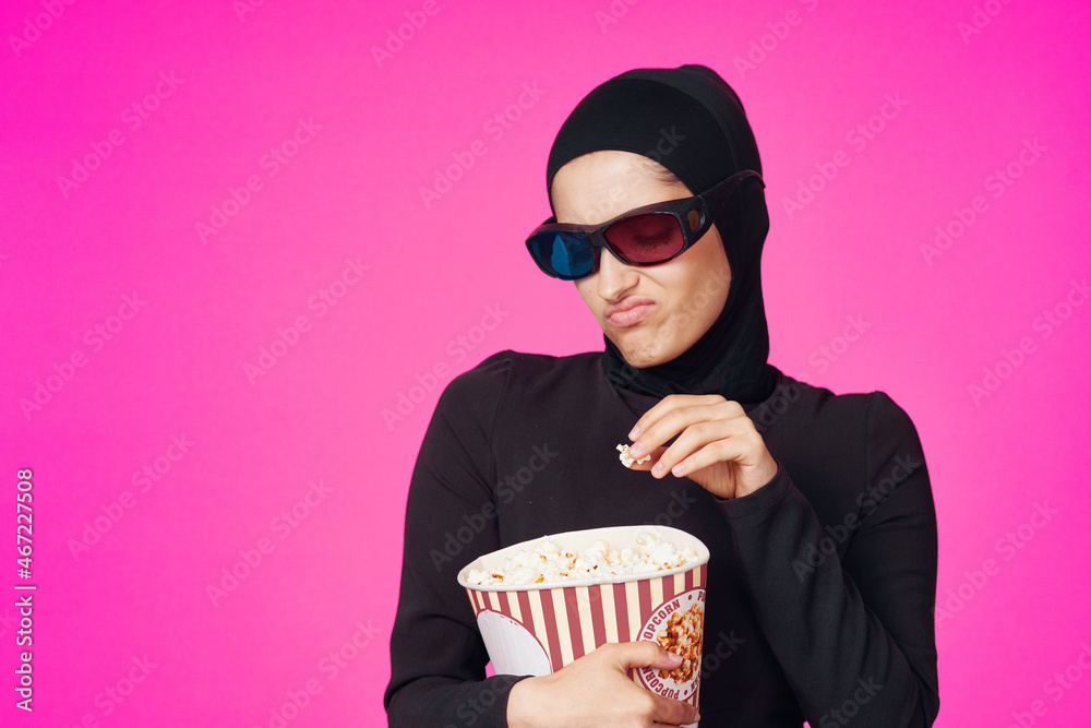 pretty woman in 3D glasses popcorn entertainment movies purple background