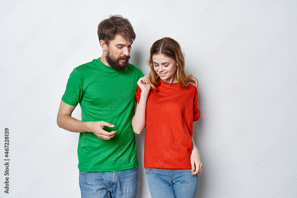 a young couple hug friendship colorful t-shirts family light background a young couple hug friendship colorful t-shirts family light background