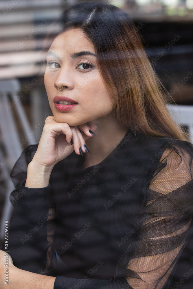 Portrait of attractive latin businesswoman looking at camera in coffee shop, entrepreneur working outside office. Business concept Portrait of attractive latin businesswoman looking at camera in coffee shop, entrepreneur working outside office. Business concept