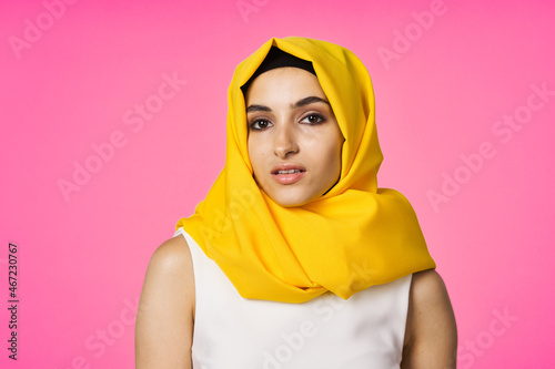 muslim woman in hijab posing fashion ethnicity pink background © VICHIZH