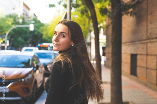 Young caucasian woman walking through the streets of Madrid, Spain.