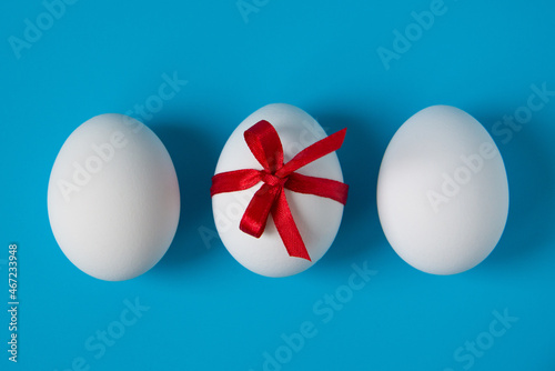 Eggs with a red bow on a blue background