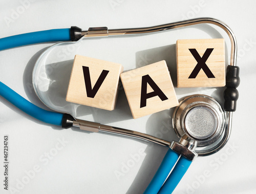 Vax word. Medical vaccination concept with blue stethoscope photo