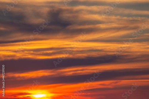 dramatic fiery sunset with clouds and bright sun. © Sviatoslav Khomiakov