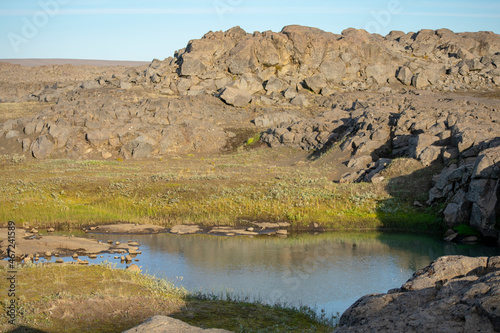 Landscape of water and basalt rocks on Detifoss trail Diamond Circle Iceland photo