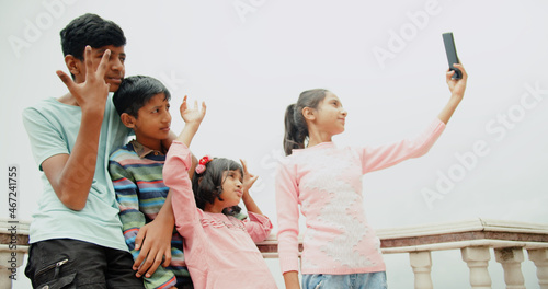 Photography South Asian childre from India taking selfies on phone
