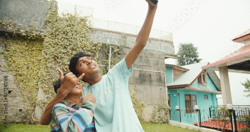 Photography South Asian boy from India taking selfies on phone