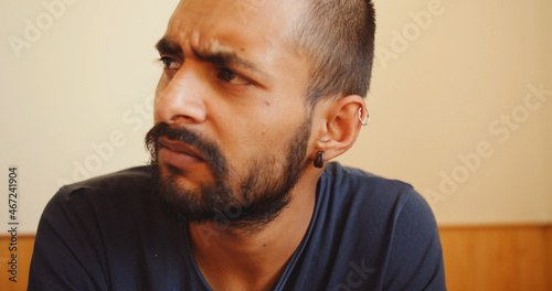 Φωτογραφία Close up of a  dissatisfied South Asian man from India