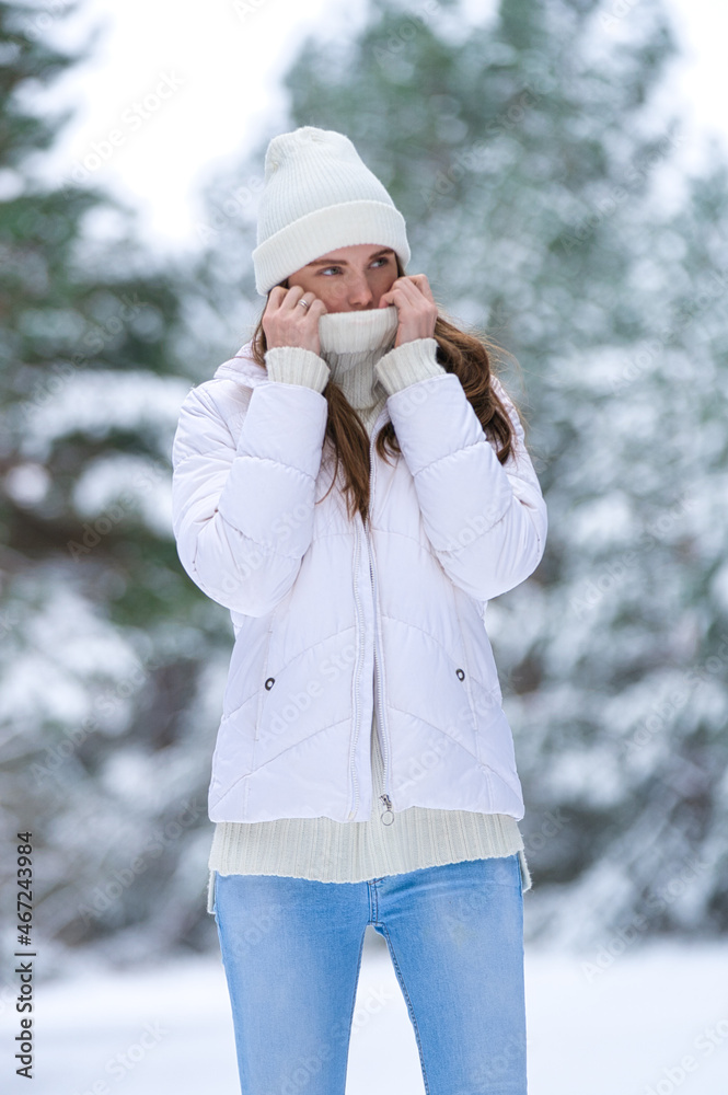Close up portrait of happy girl in jacket enjoying winter moments. Outdoors photo of a long-haired laughing lady in a knitted hat having fun on a snowy morning on a blurred background of wood Close up portrait of happy girl in jacket enjoying winter moments. Outdoors photo of a long-haired laughing lady in a knitted hat having fun on a snowy morning on a blurred background of wood