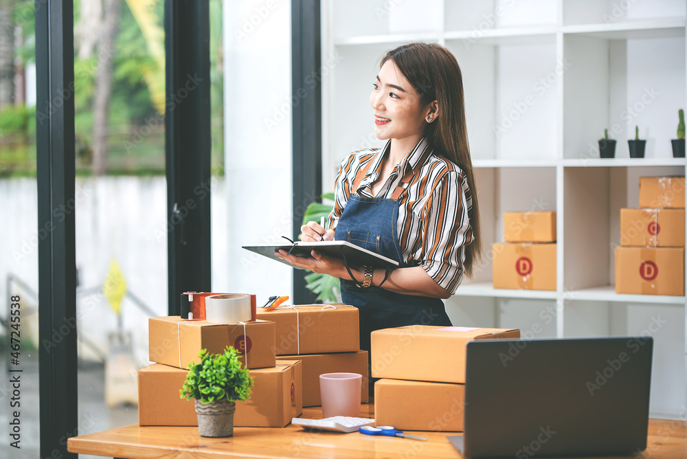 Small start-up business owners checking parcels at work, freelancers, salespeople, checking production orders. Pack products for delivery to customers Sell Ecommerce Shipping Ideas Small start-up business owners checking parcels at work, freelancers, salespeople, checking production orders. Pack products for delivery to customers Sell Ecommerce Shipping Ideas