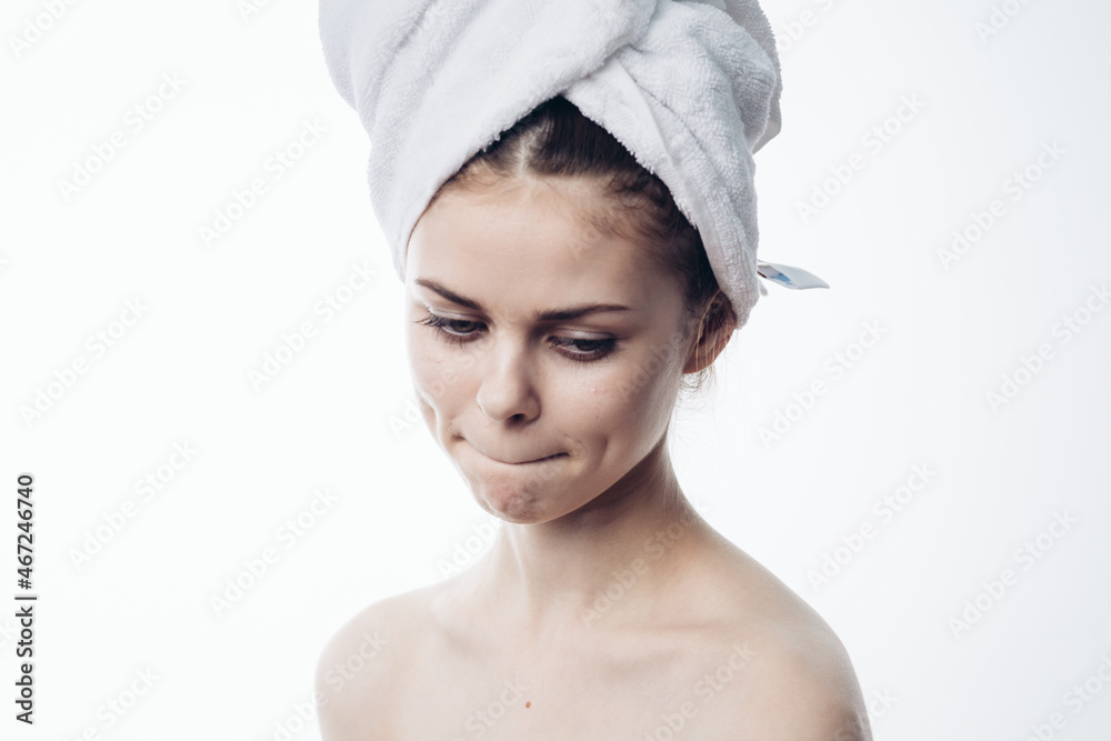 woman after shower with towel on head posing skin care