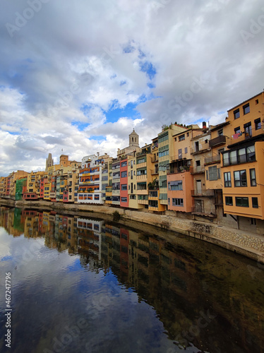 Colorful historical houses facades  reflected in water of the river Onyar  in Girona  Catalonia  Spain. 