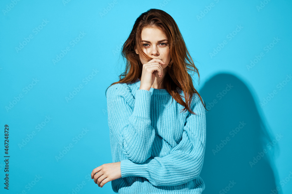 pretty woman in a blue sweater isolated background pretty woman in a blue sweater isolated background