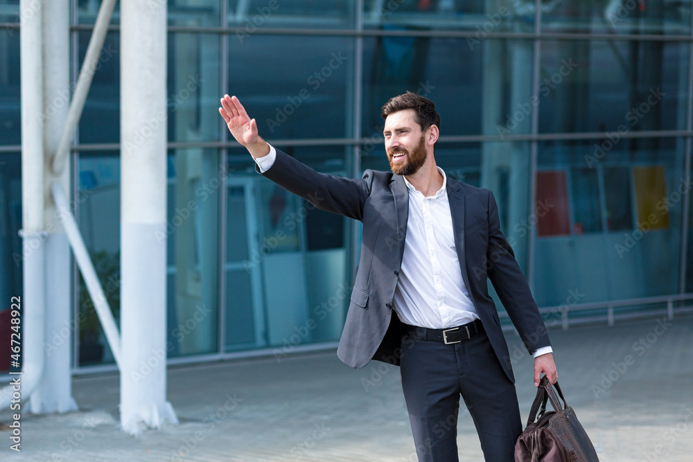 Male businessman can not catch free taxi at busy time. business man does not successfully stop a taxi on a city street. can't catch a car on the road waving his hand. standing on the sidewalk outside Male businessman can not catch free taxi at busy time. business man does not successfully stop a taxi on a city street. can't catch a car on the road waving his hand. standing on the sidewalk outside
