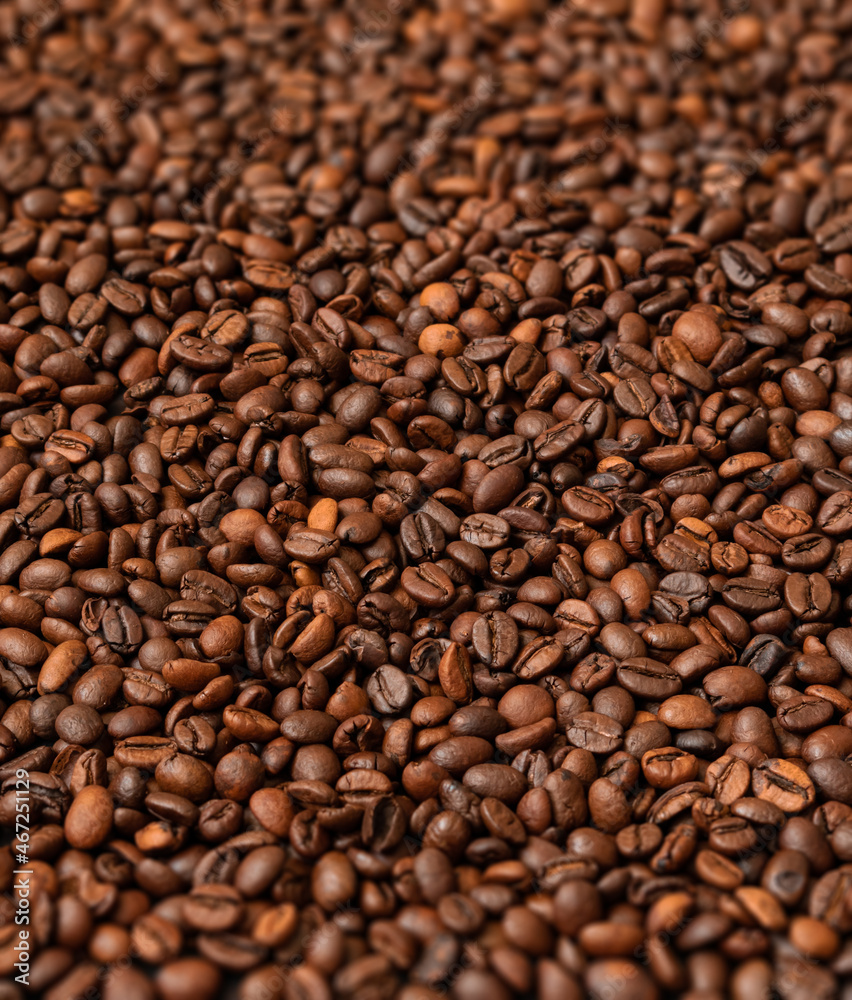 Fresh roasted coffee beans background. Selective focus.