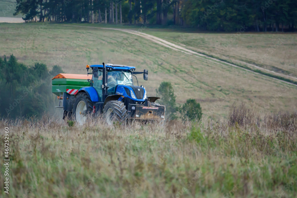 large blue New Holland T7.260 tractor fitted with an Amazone Profis Hydro hopper spreader large blue New Holland T7.260 tractor fitted with an Amazone Profis Hydro hopper spreader
