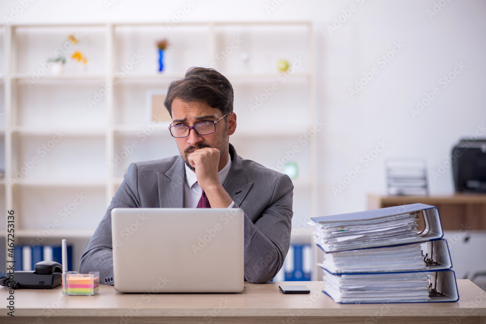 Young male employee working in the office Young male employee working in the office