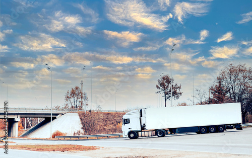 White truck with cargo on the turn on the track