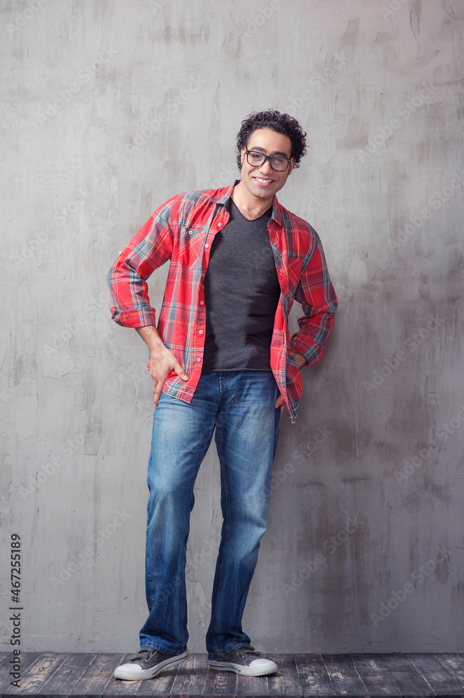 Afro-American hipster standing against grey background Afro-American hipster standing against grey background