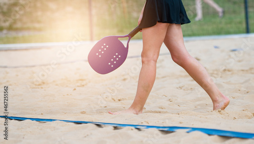 Woman playing beach tennis on a beach. Professional sport concept
