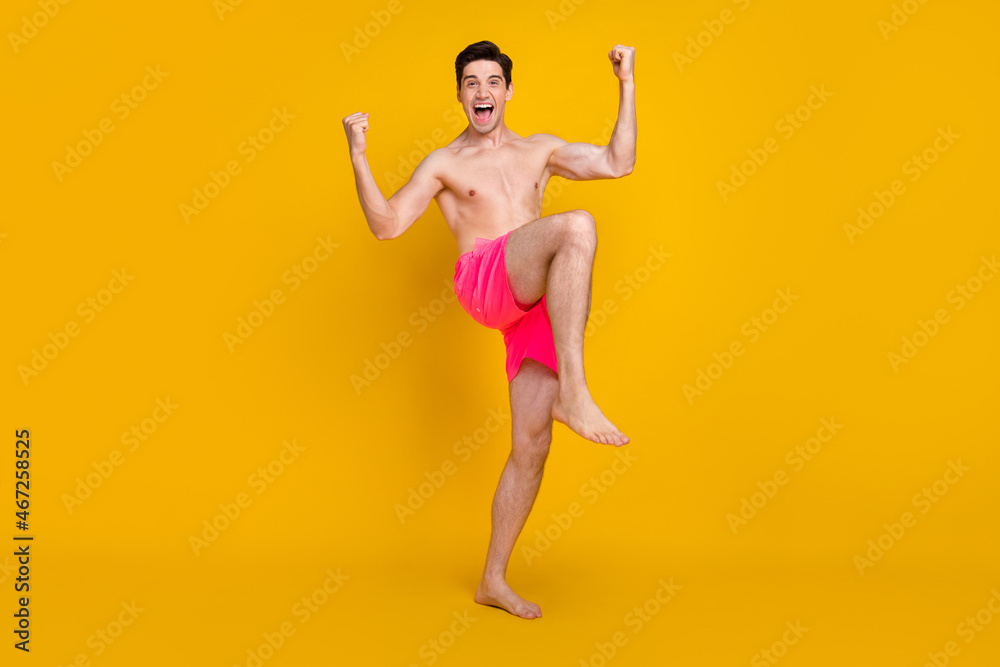 Obraz premium Full length photo of young man happy positive smile celebrate lucky winner trip isolated over yellow color background