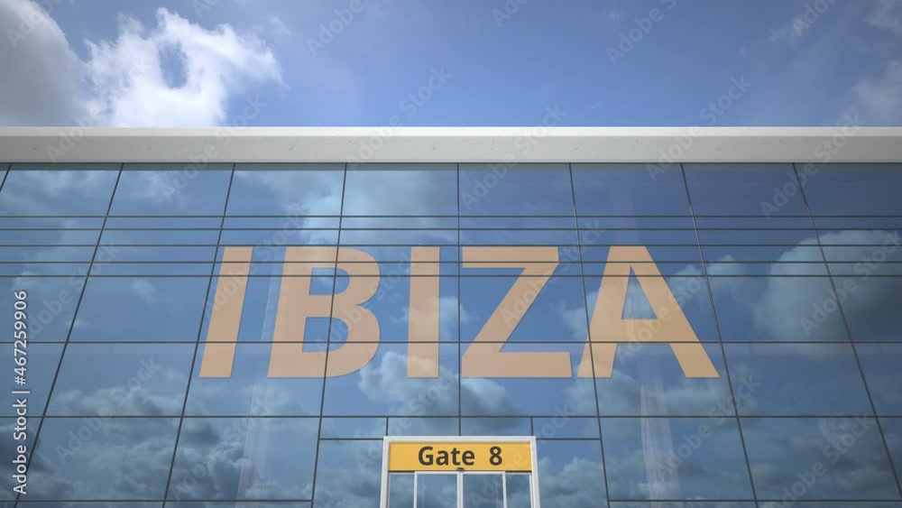 Plane reflects in the airport terminal with IBIZA city name