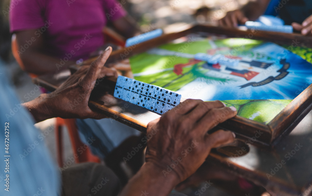 Playing dominoes. Person hands. Street game Dominican Republic Caribbean - obrazy, fototapety, plakaty 