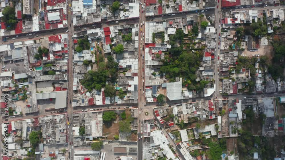 Aerial birds eye overhead top down panning view of town with streets and blocks of houses. Square pattern of city. Valladolid, Mexico Aerial birds eye overhead top down panning view of town with streets and blocks of houses. Square pattern of city. Valladolid, Mexico