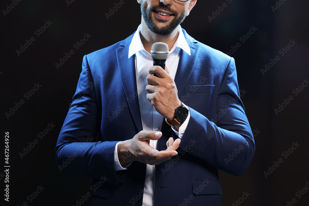 Motivational speaker with microphone performing on stage, closeup - obrazy, fototapety, plakaty 