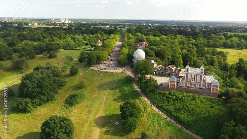 Observatory and Flamsteed House on top of Greenwich hill. Backwards reveal of people in park. London, UK photo