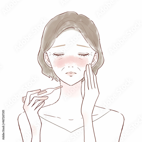 体温計で熱を測る中年女性