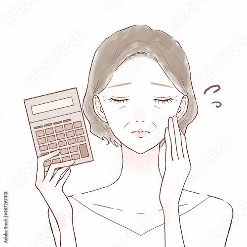 電卓を持っている中年女性　困っている表情