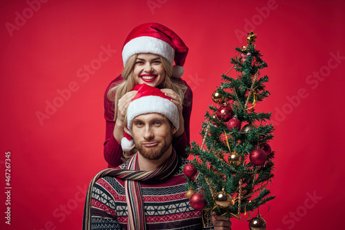 woman next to man family portrait christmas tree decoration holiday