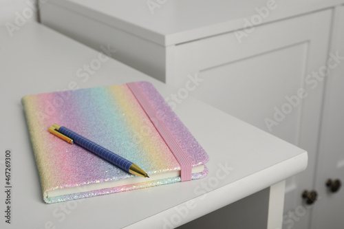 Bright planner and pen on white table indoors, space for text