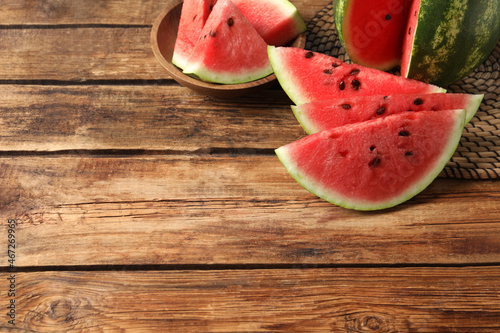 Delicious fresh watermelon slices on wooden table. Space for text