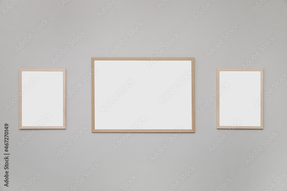 Empty frames on grey wall. Mockup for design Empty frames on grey wall. Mockup for design