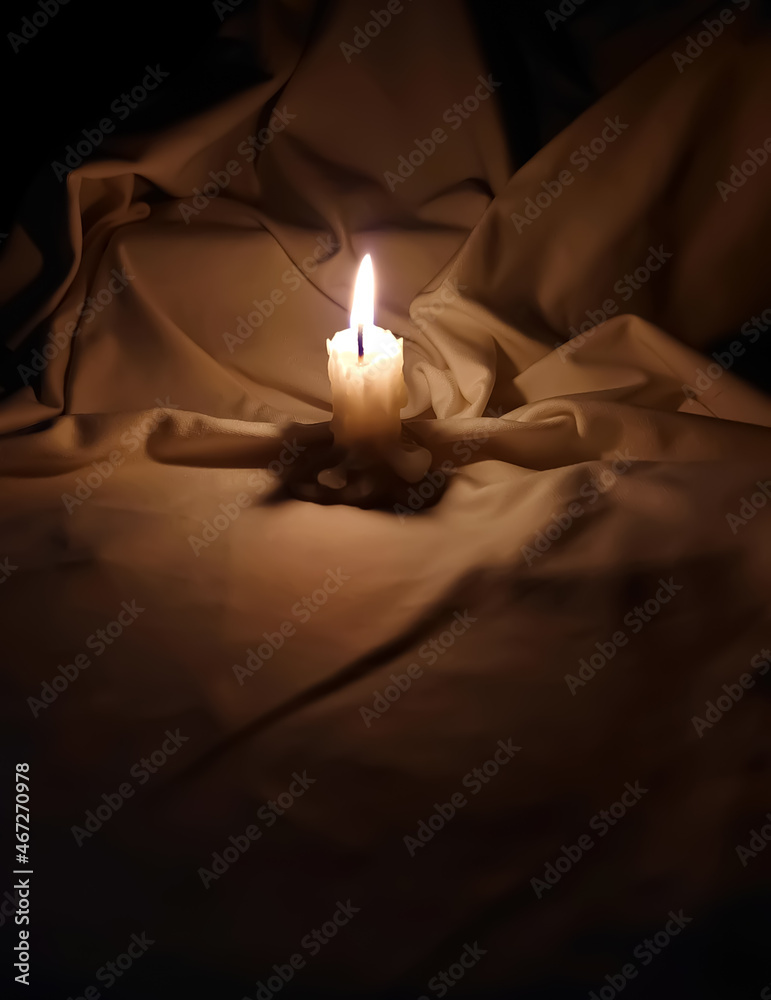 Candle shining in a dark white background. Candle shining in a dark white background.