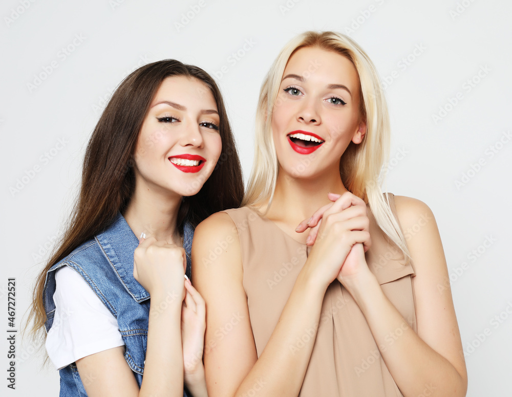 lifestyle and people concept: Two young girl friends standing to lifestyle and people concept: Two young girl friends standing to