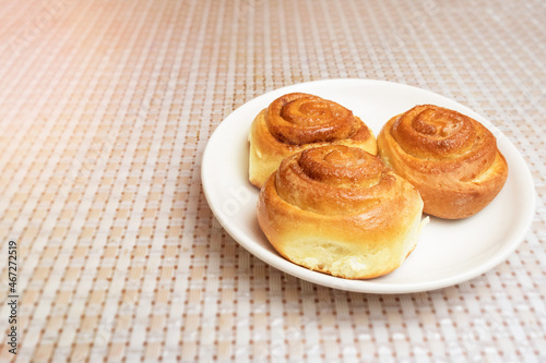 homemade buns on a white plate on the table. Homemade buns recipe. fresh bakery.
