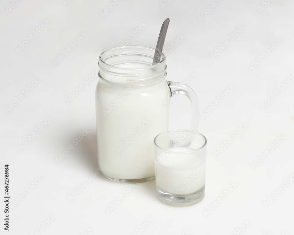White milk drink served with bread is good for breakfast in the morning. This fresh cow's milk in addition to its sweet taste also contains many nutrients. warm milk in a glass cup.