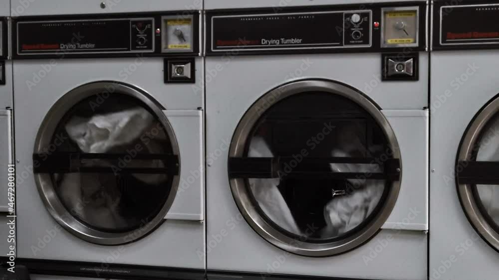 Multiple laundry machines spinning in slowmotion. 100 fps. Multiple laundry machines spinning in slowmotion. 100 fps.
