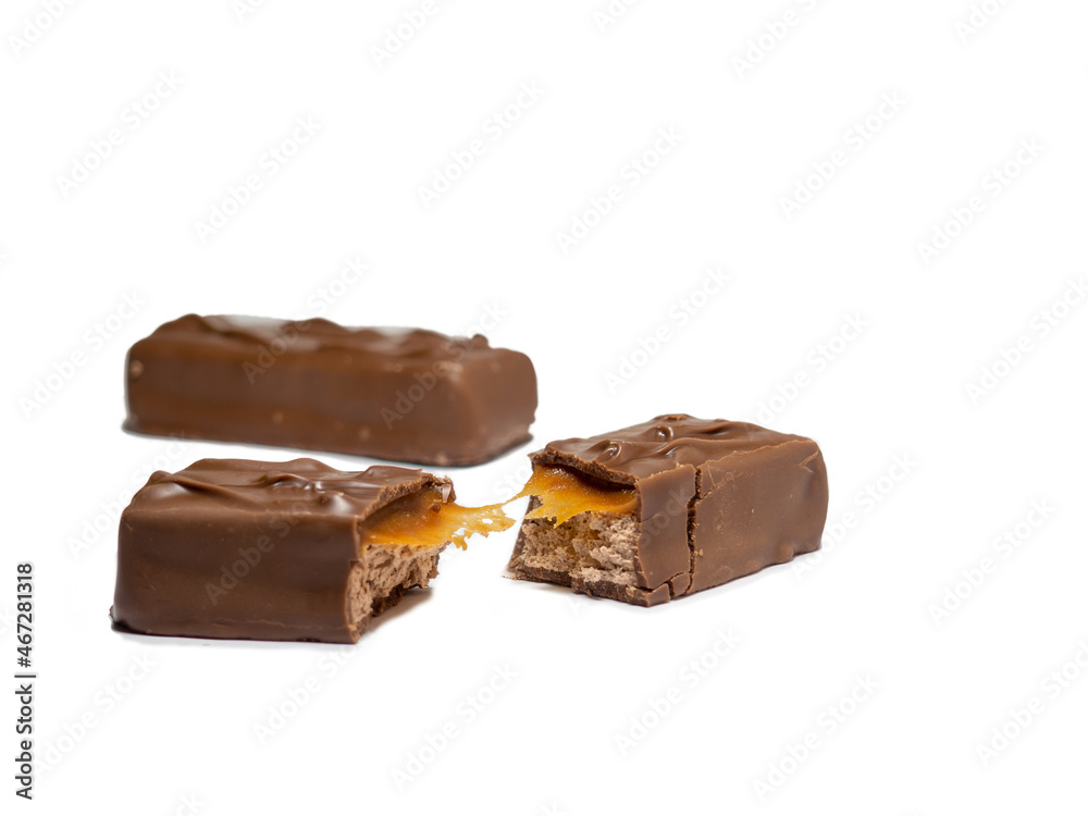 Broken chocolate bar on a white background. Slices of chocolate.