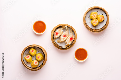 Top View of Assorted Chinese Dimsum in bamboo basket. Dimsum is a large range of small dishes that Cantonese people traditionally enjoy in restaurants for breakfast and lunch.