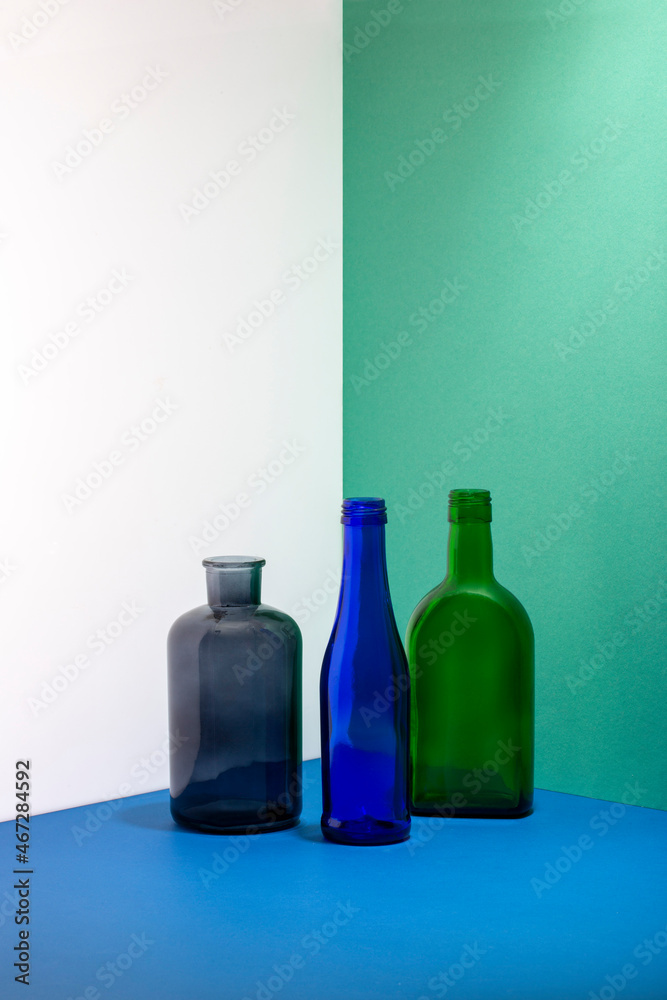 Still life with glass bottles on a colored background Still life with glass bottles on a colored background