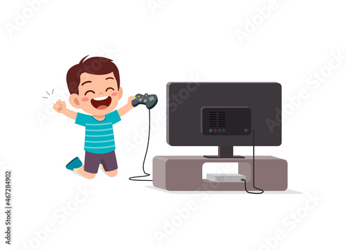 cute little boy play video game on big screen