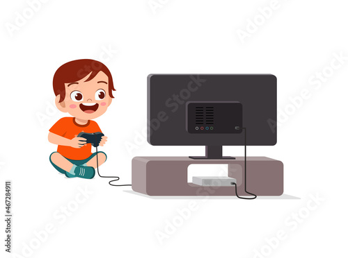 cute little boy play video game on big screen