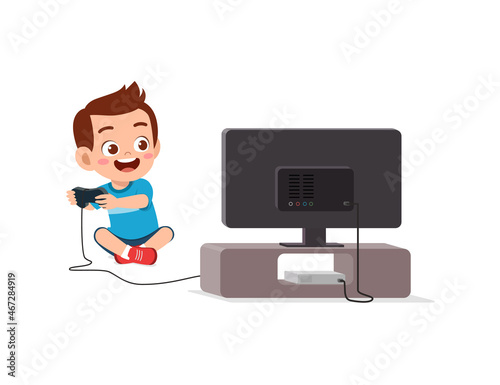 cute little boy play video game on big screen