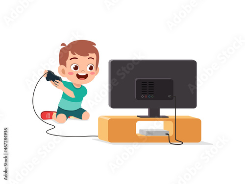 cute little boy play video game on big screen